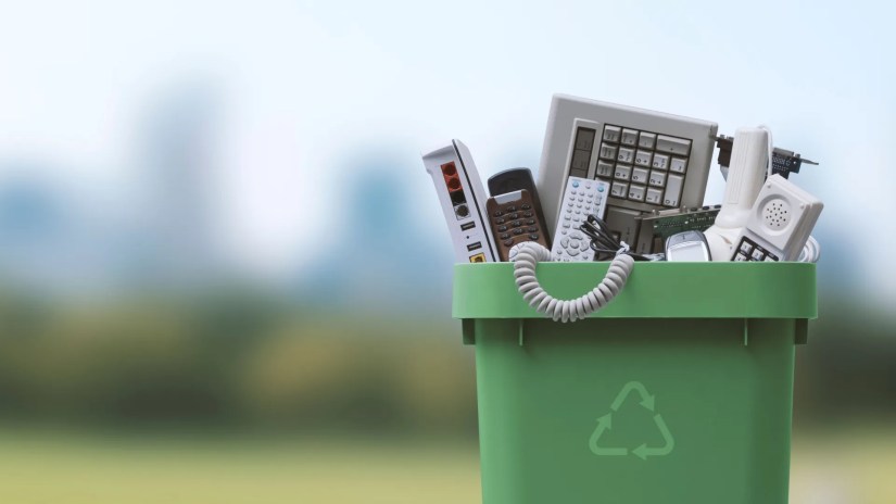 Waste bin full of electronics, e-waste and recycling.
