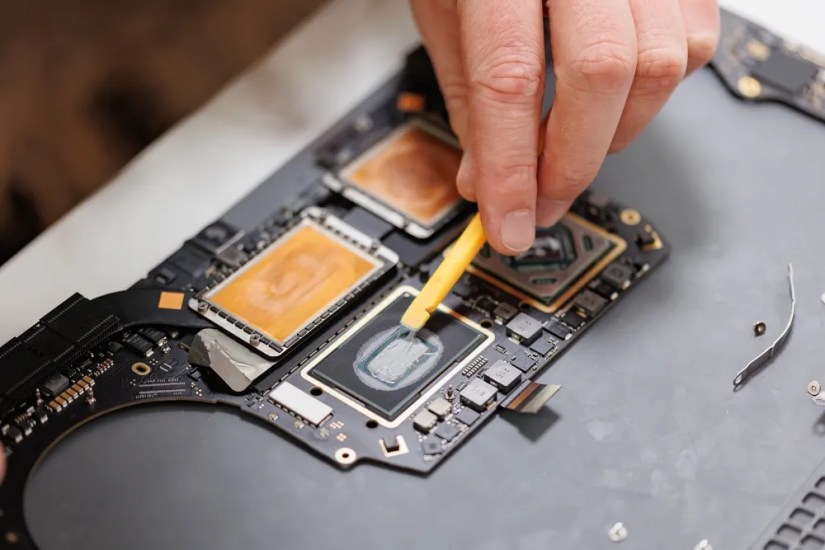 A technician working on a Macbook.