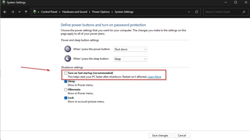 Screenshot of Windows 11 Power Options showing the “Turn on fast startup” setting unchecked, with the option highlighted in red and a red arrow pointing to it.