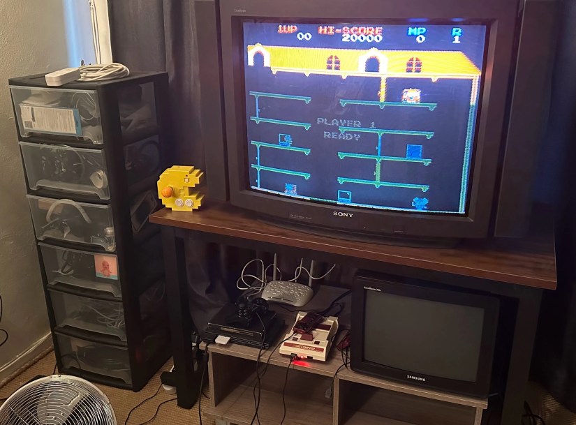 A plastic filing cabinat next to a CRT TV.