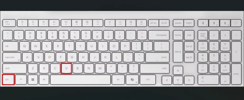 White keyboard with red boxes highlighting the Ctrl and V keys.