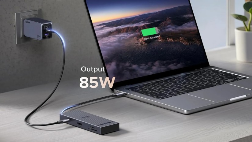 UGREEN&rsquo;s Revodok Pro 8-in-1 USB-C Hub plugged into a laptop charging it.