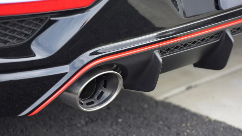 Close-up shot of one of the exhaust tips and rear diffuser on a blue 2022 Hyundai Veloster N.