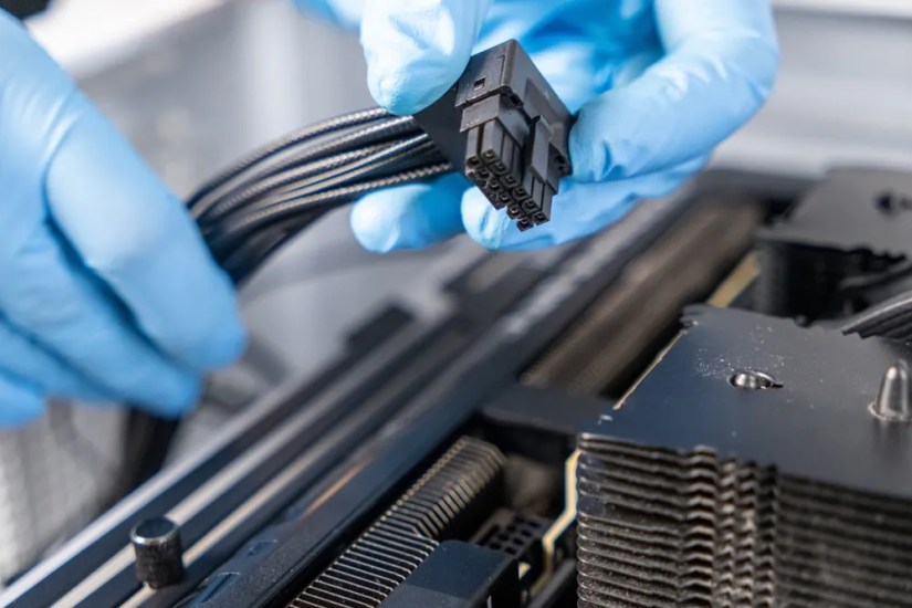 A PCIe cable being attached to a GPU.