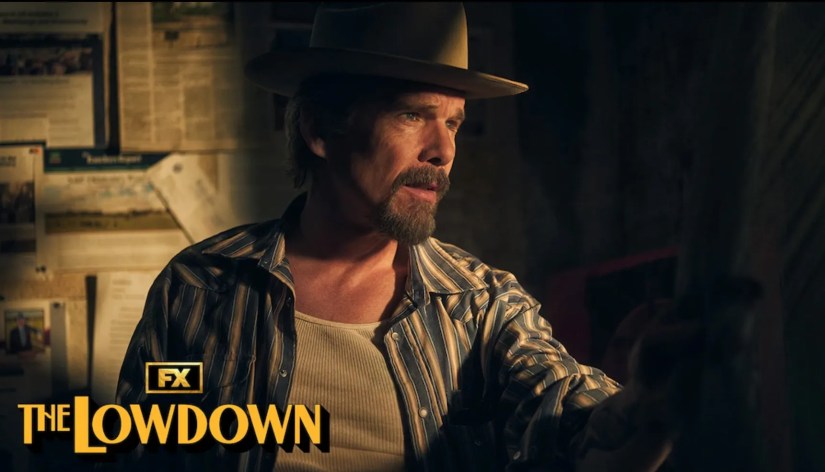 Ethan Hawke in cowboy hat staring out window.