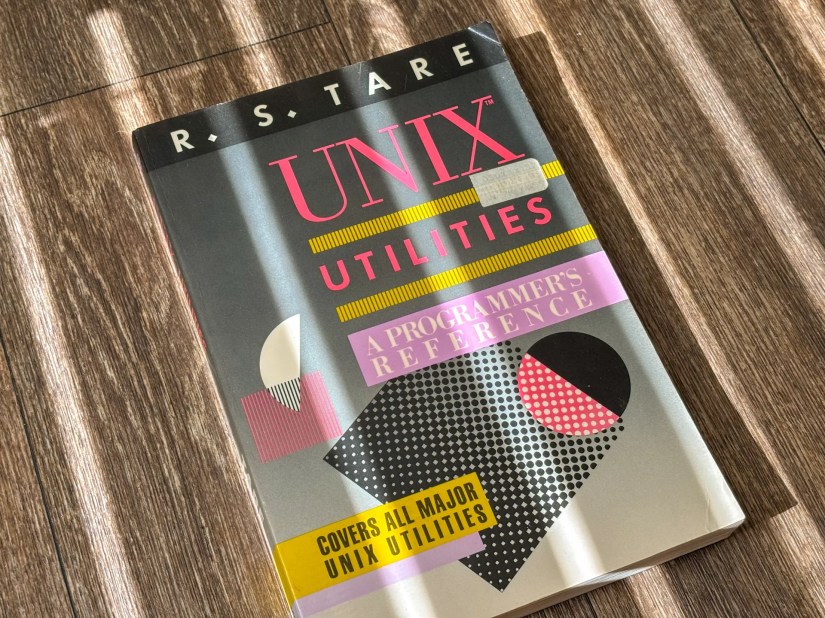 A book titled &ldquo;UNIX Utilities&rdquo; by R. S. Tare, featuring a vintage design with geometric shapes.