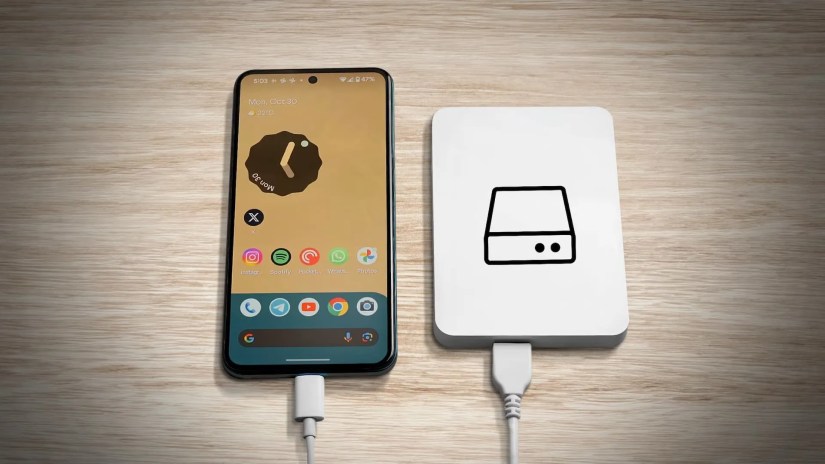 An Android phone on the left with android home screen and a Hard Drive on the right with a hdd logo.