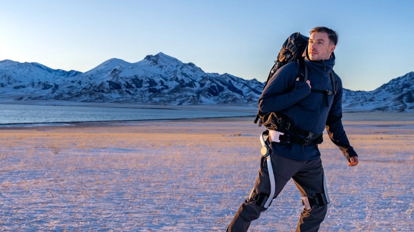 Hypershell X man walking through mountainous terrain