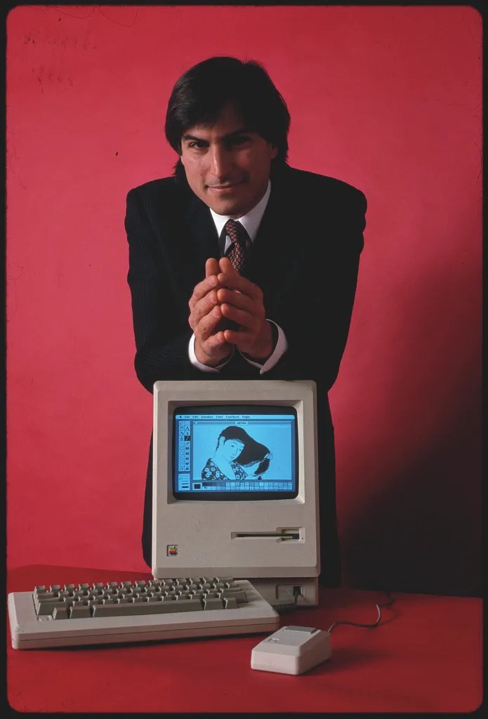 Steve Jobs with a Macintosh 128K.