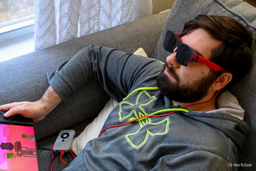Person using the XReal Air 2 Glasses to play on a handheld gaming console.