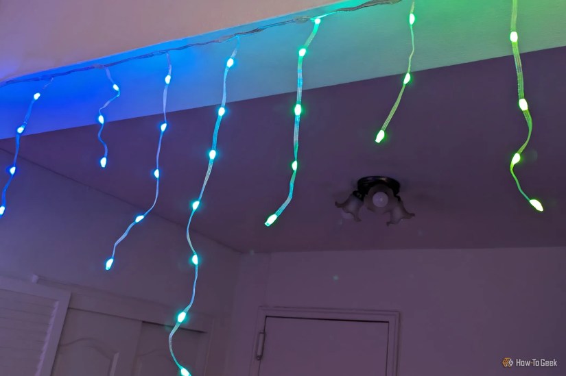 Dangling Govee Icicle Lights of differing lengths in an indoor entryway.