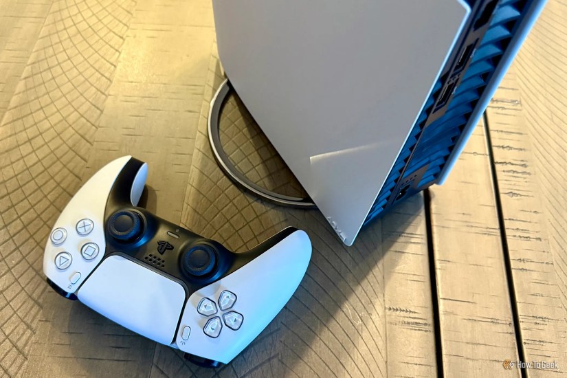 Sony PlayStation 5 Pro with vertical stand and focus on DualSense wireless controller.