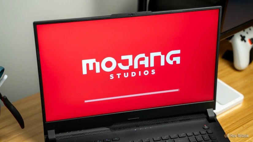 The Mojang Studios logo on a laptop that is launching Minecraft.