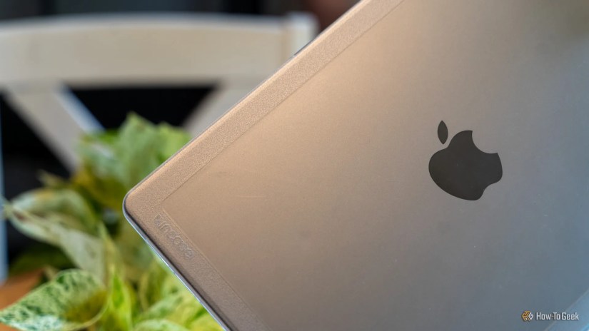 The Incase logo on the Edge Hardshell Case with the Apple logo also visible and a plant in the background.