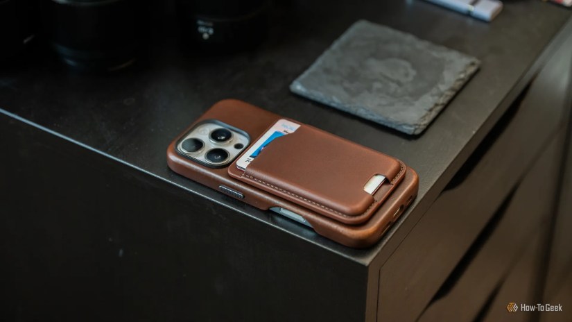 Nomad Leather Mag Wallet attached to an iPhone 16 Pro sitting on a table.