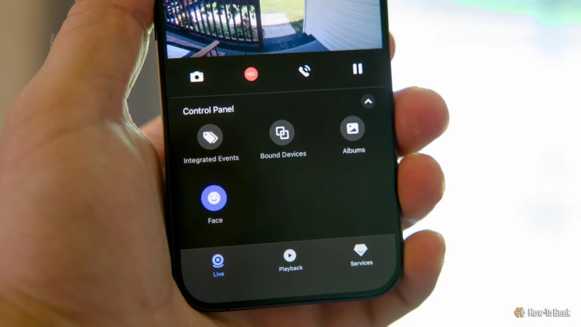 A hand holding an iPhone showing the Aqara app with the on-device facial recognition icon illuminated.