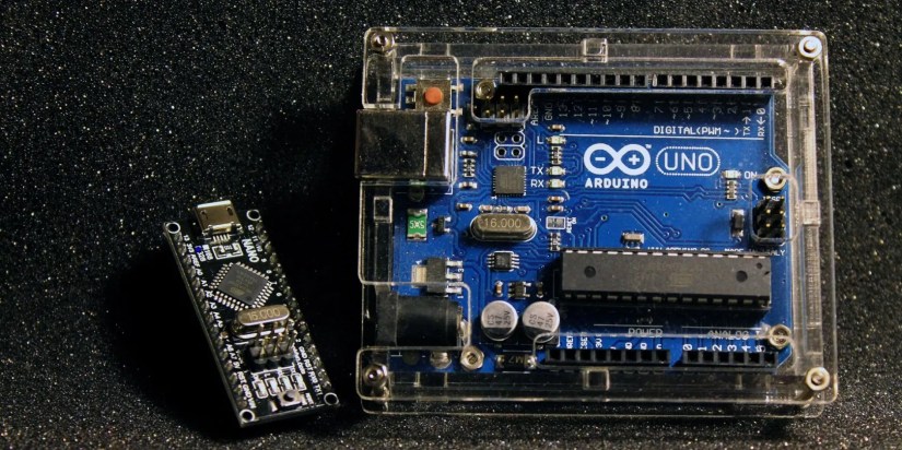 Arduino UNO in a case beside an Arduino Nano