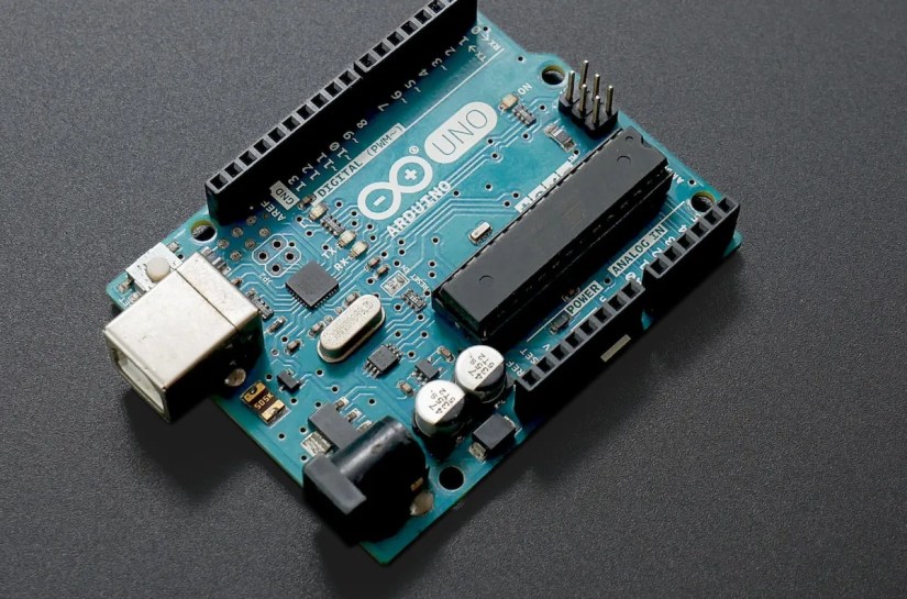 Arduino Uno board on black surface