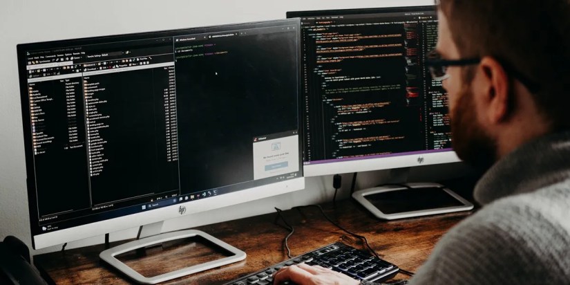 man coding on laptop