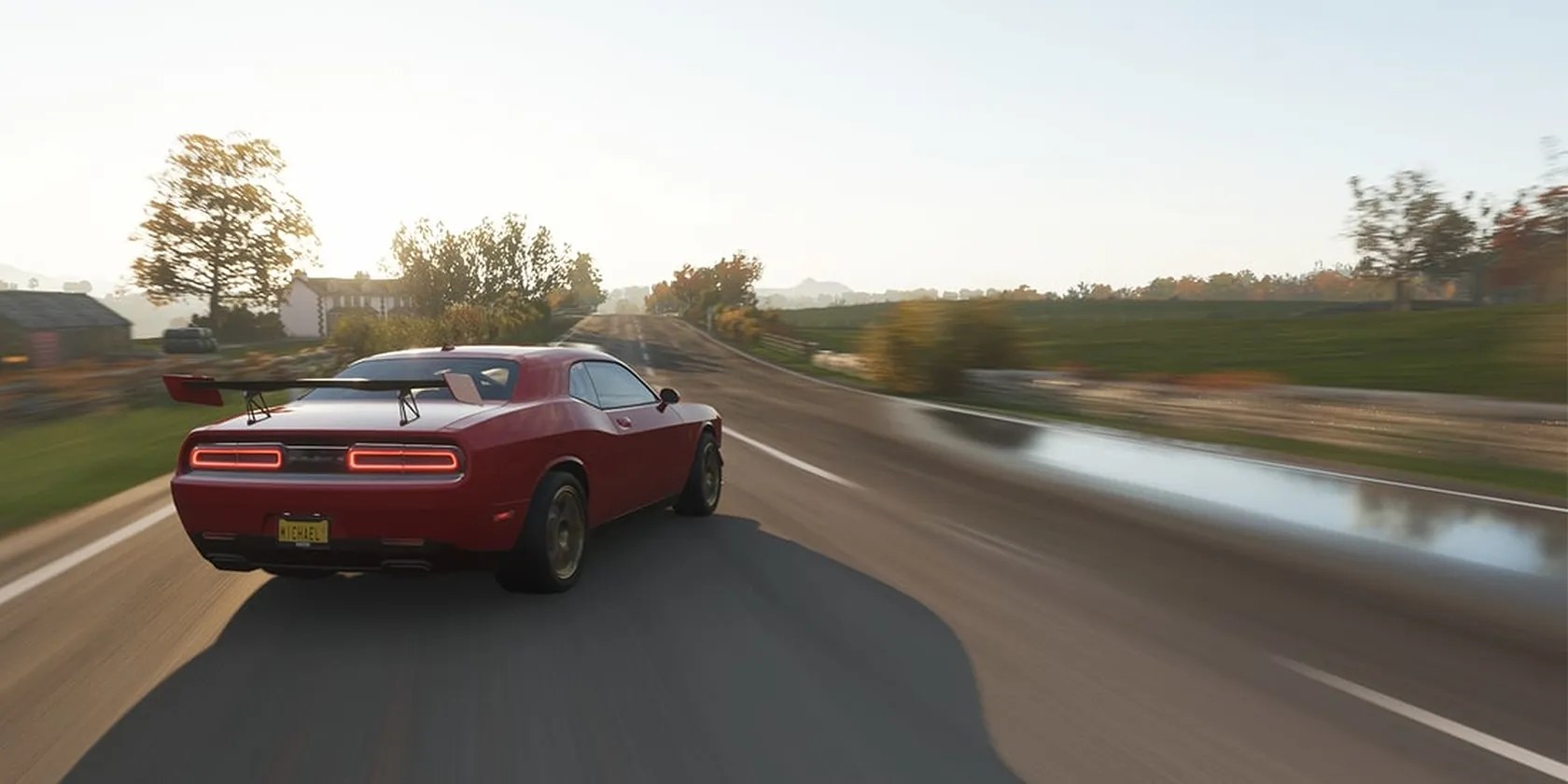 A Dodge Challenger drifting down a suburban street