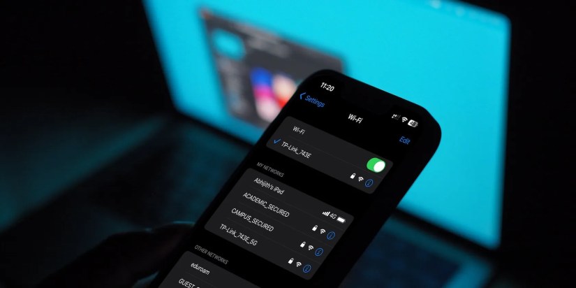 iphone wifi menu with a macbook in the background