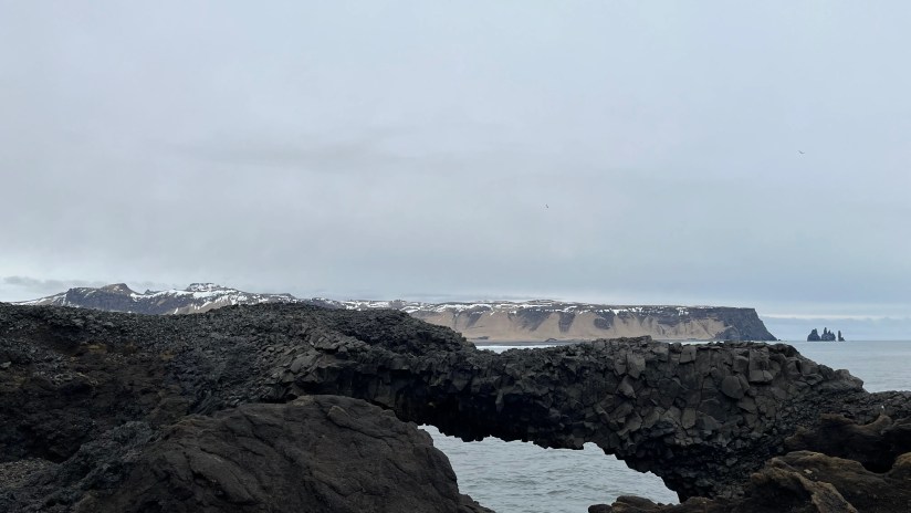 A landscape photo taken through an object on a cliff
