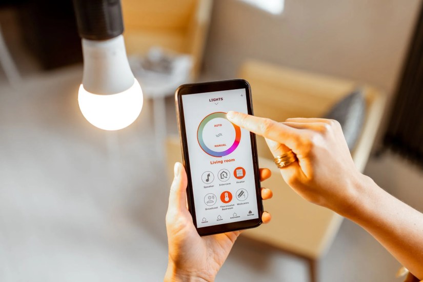 a person using an app to change colors on a smart bulb
