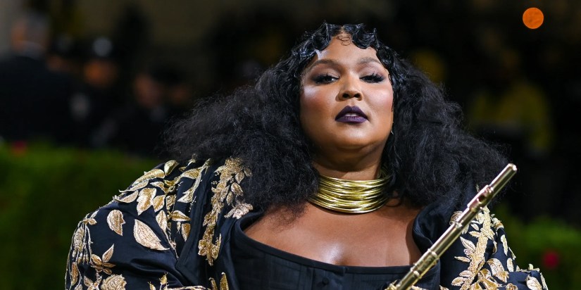 Lizzo during a performance while holding her flute