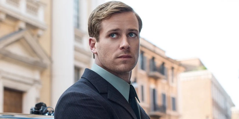 Armie Hammer as Illya Kuryakin looking over his shoulder in The Man From Uncle