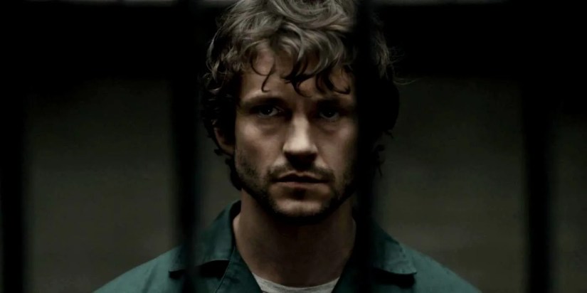 Will (Hugh Dancy) with a neutral expression and behind bars in Hannibal