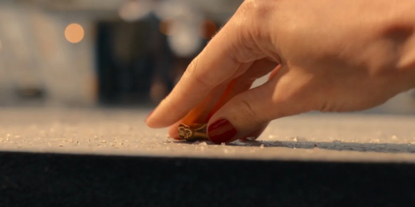 A hand picks up the Master’s tooth in Doctor Who episode “The Giggle."
