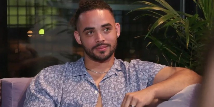 Rob Warne In 90 Day Fiance wearing unbuttoned printed shirt and looking at Sophie&rsquo;s friend Callum