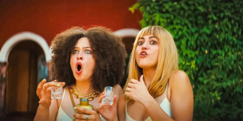 Heather and Camila with exaggerated expressions of surprise in Blink Twice (2024)