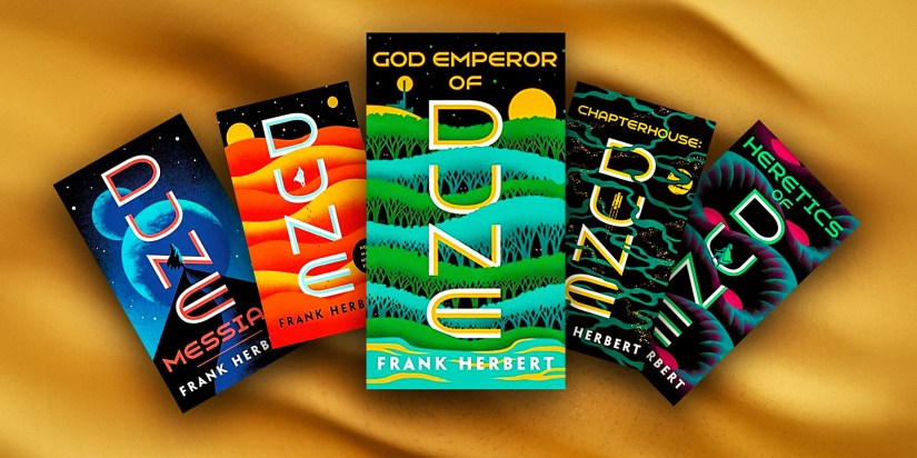 Several of Frank Herbert&rsquo;s Dune books with sand background