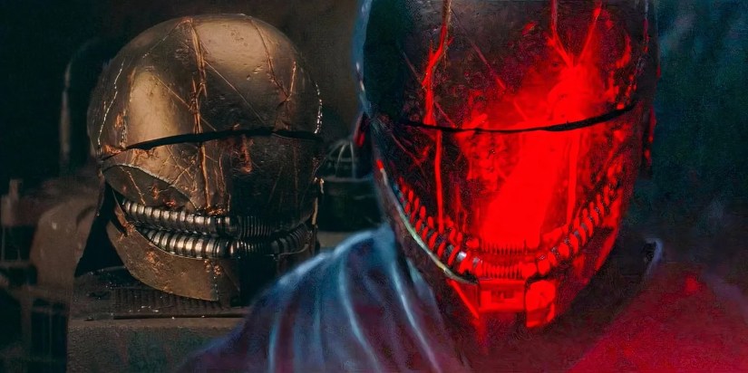 The Stranger&rsquo;s helmet on a table and on his head, illuminated by red light, in The Acolyte