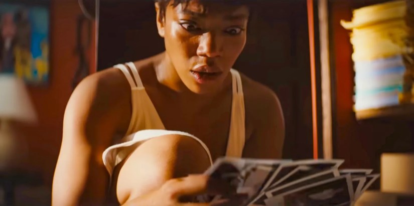 Frida (Naomi Ackie) shocked upon discovering a bunch of polaroids in Blink Twice (2024)