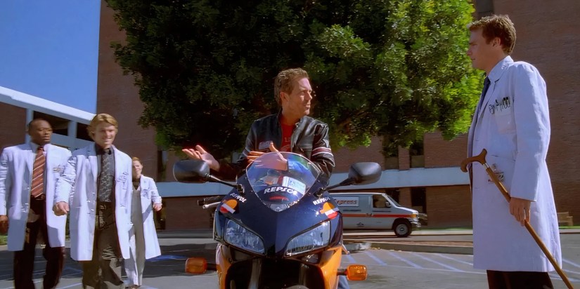 Hugh Laurie as Gregory House showing off his new motorcycle to his colleagues in the House episode Daddy&rsquo;s Boy.