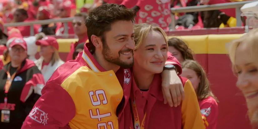 Hunter King as Alana Higman hugging Tyler Hynes as Derrick Taylor in Holiday Touchdown: A Chiefs Love Story trailer.