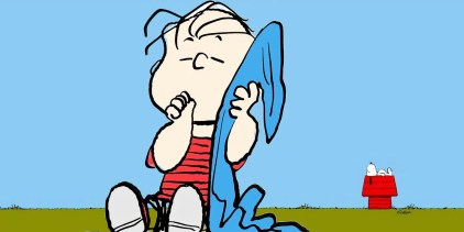 Peanuts: Linus with his blanket with Snoopy behind him lying on his doghouse looking up at a blue sky.