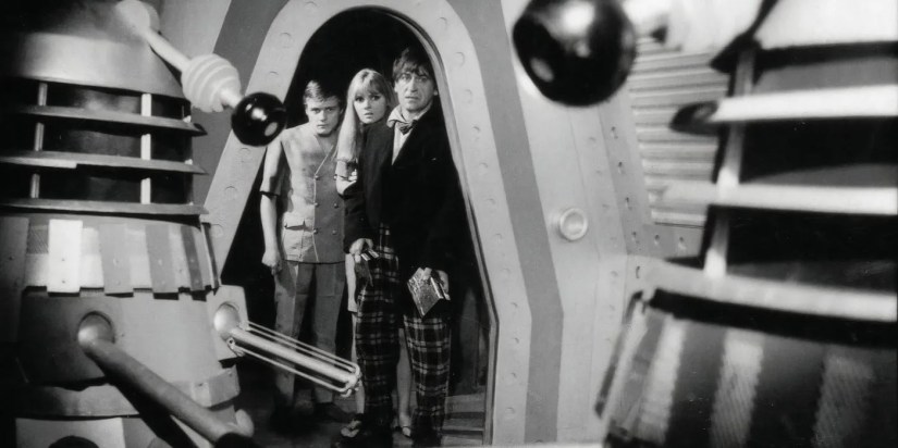 The Second Doctor, Polly, and Ben watching a Dalek in the Doctor Who serial &ldquo;The Power of the Daleks.&quot;