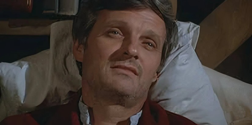 A sick Alan Alda as Hawkeye lying in bed in the MASH episode “Bless You Hawkeye."