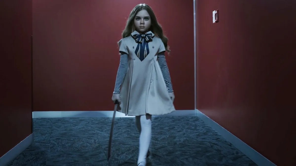 m3gan walking down a corridor with a knife