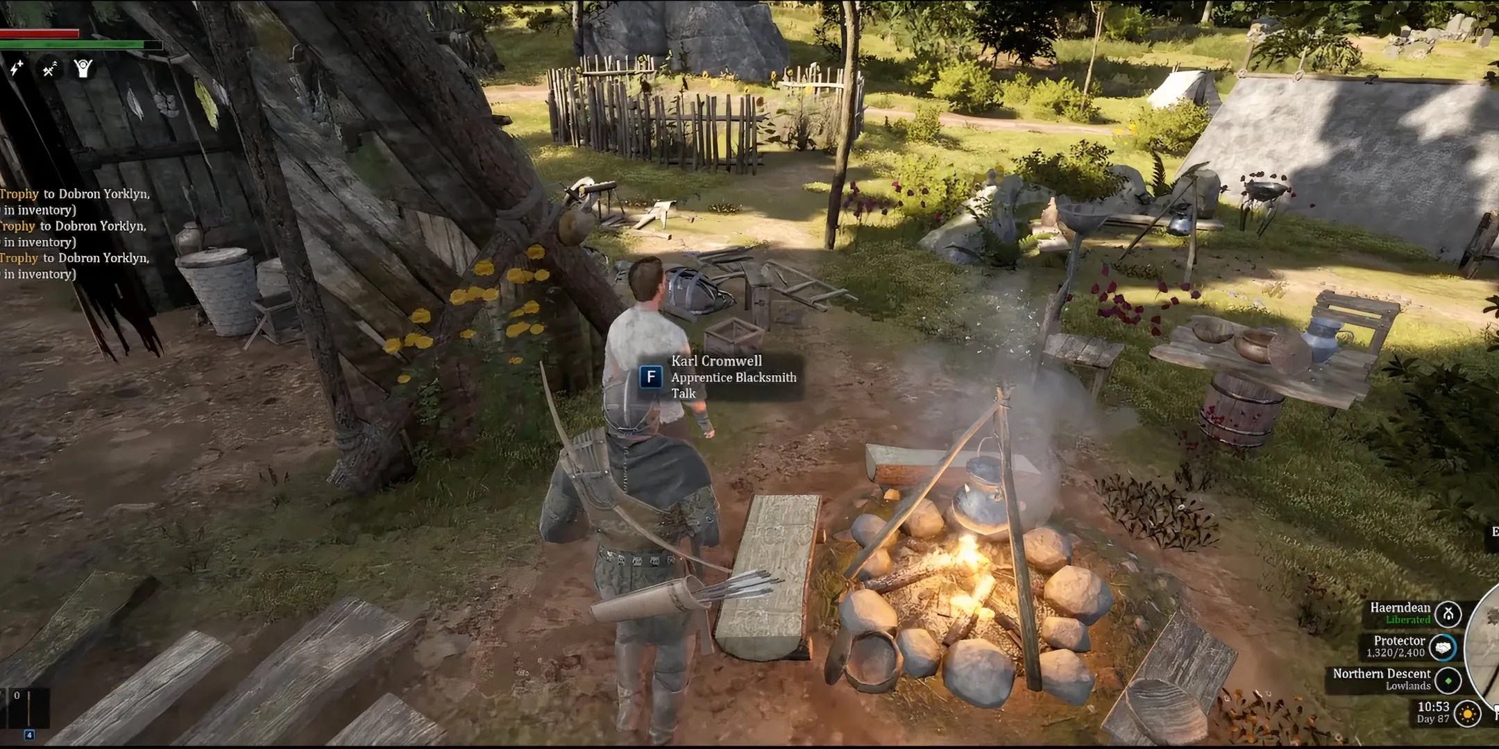 Apprentice Blacksmith stands by his campfire at his campsite