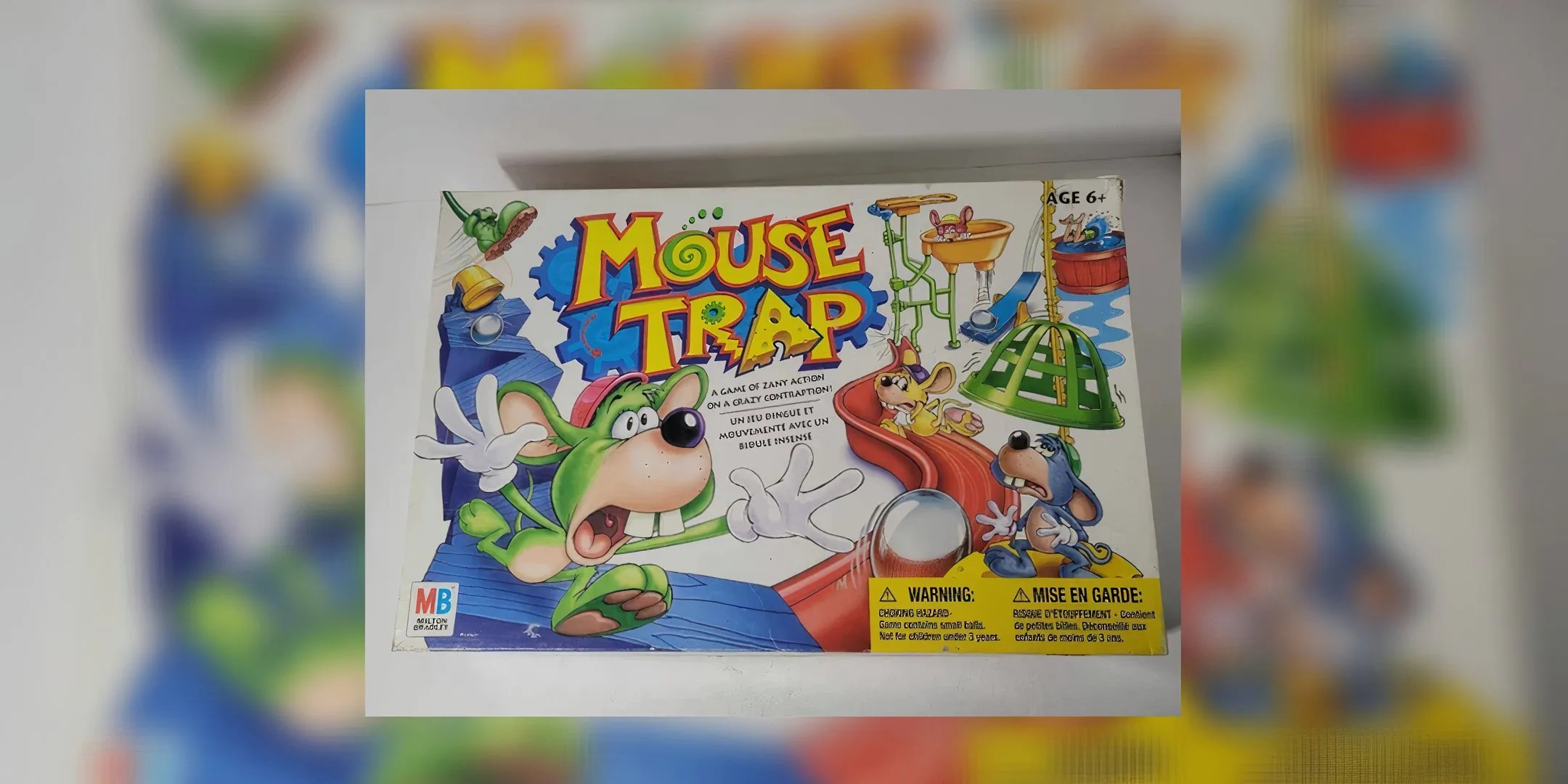 Several different colored mice are running from mouse traps in the game Mouse Trap