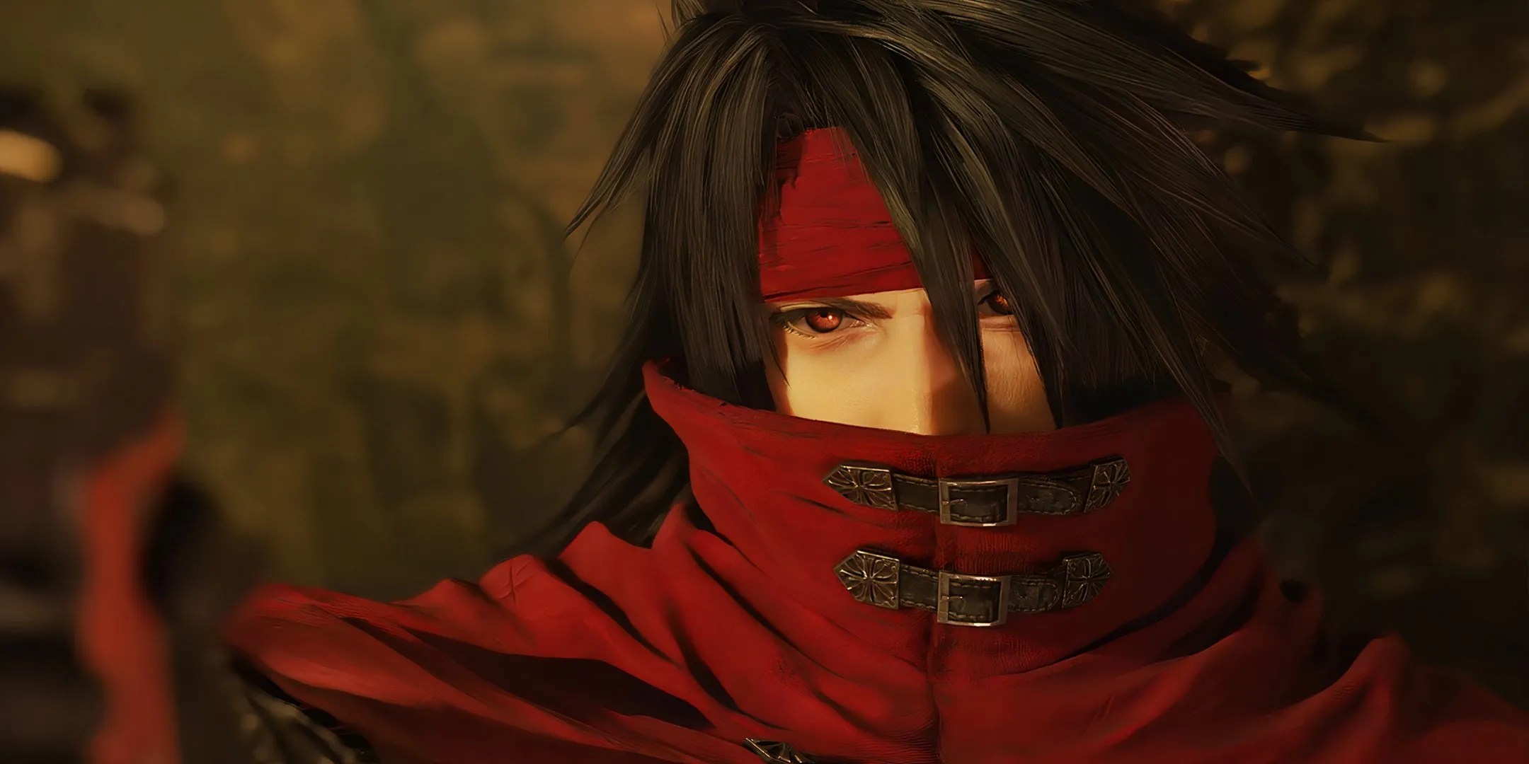 A close up of Vincent Valentine&rsquo;s face with his left eye covered with his black hair and his right eye looking intensely at the camera.