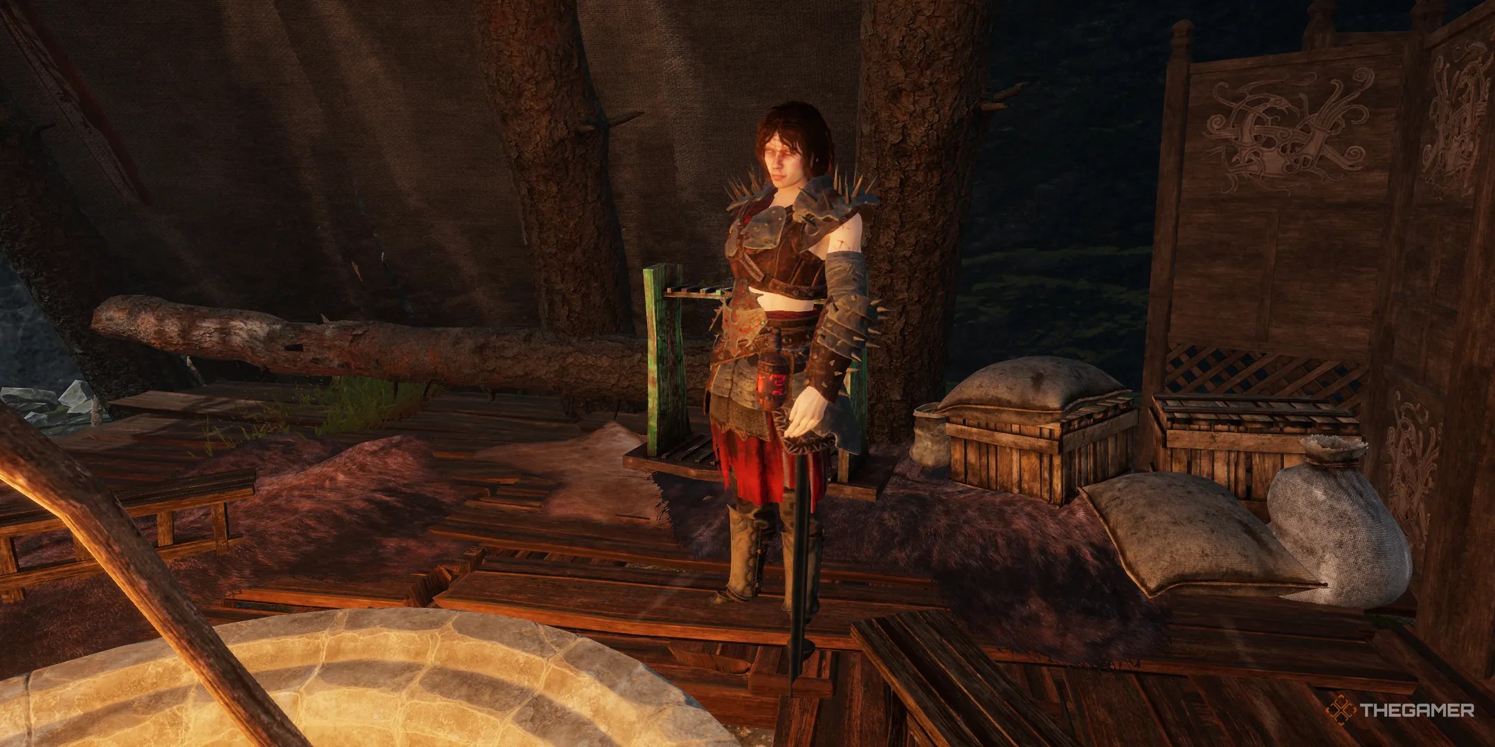 Vrann standing in the middle of her hut looking menacing in Tainted Grail The Fall of Avalon.