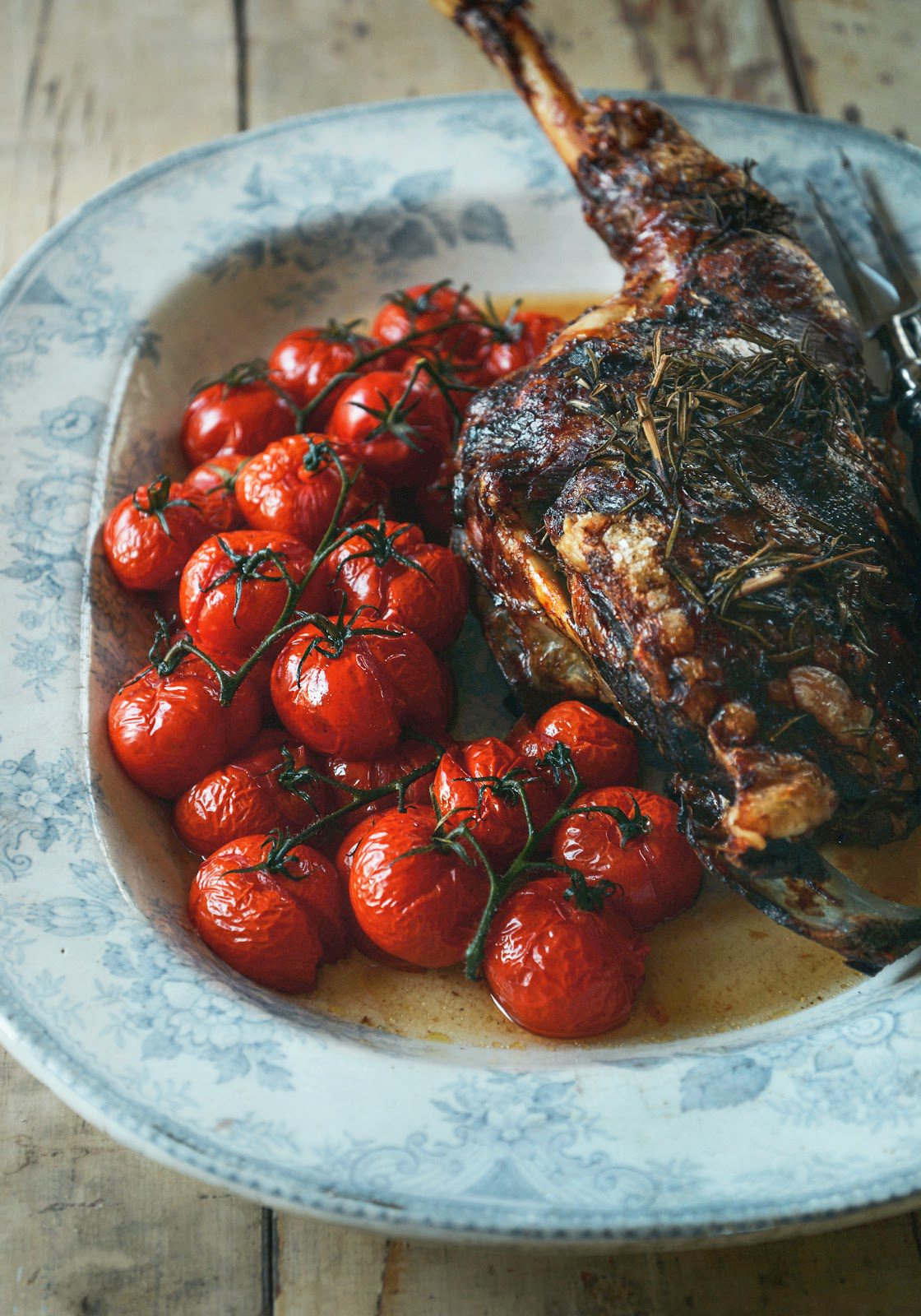 Easter slow roast lamb with rosemary, garlic, & vine tomatoes Stuck
