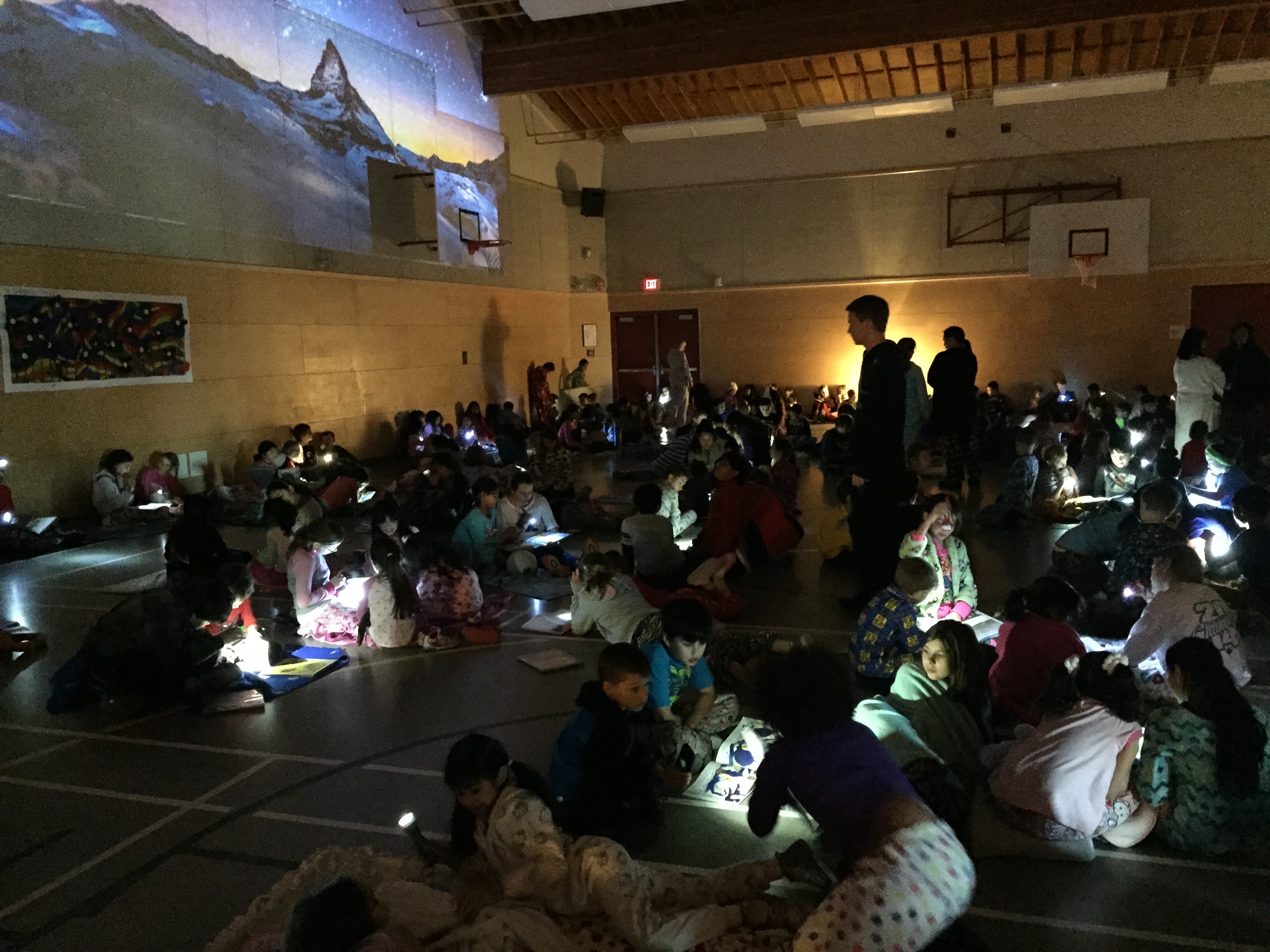Students were thrilled today because it was time for 'Reading Under the Stars'. Look at the gym - it was magical! Older students read with little buddies and model leadership, patience, and a love of reading.