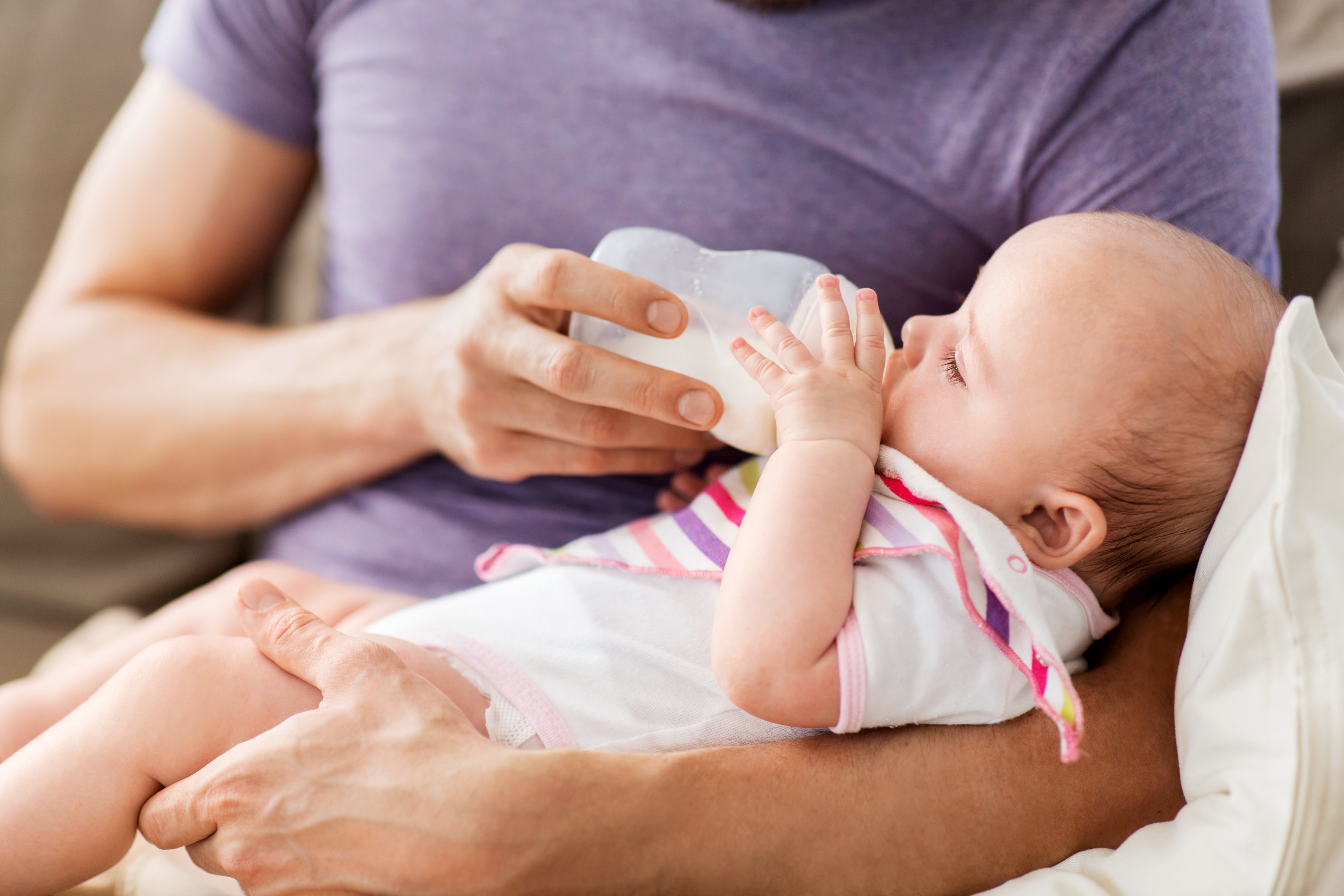 close up of father feeding baby from bottle Tales of a