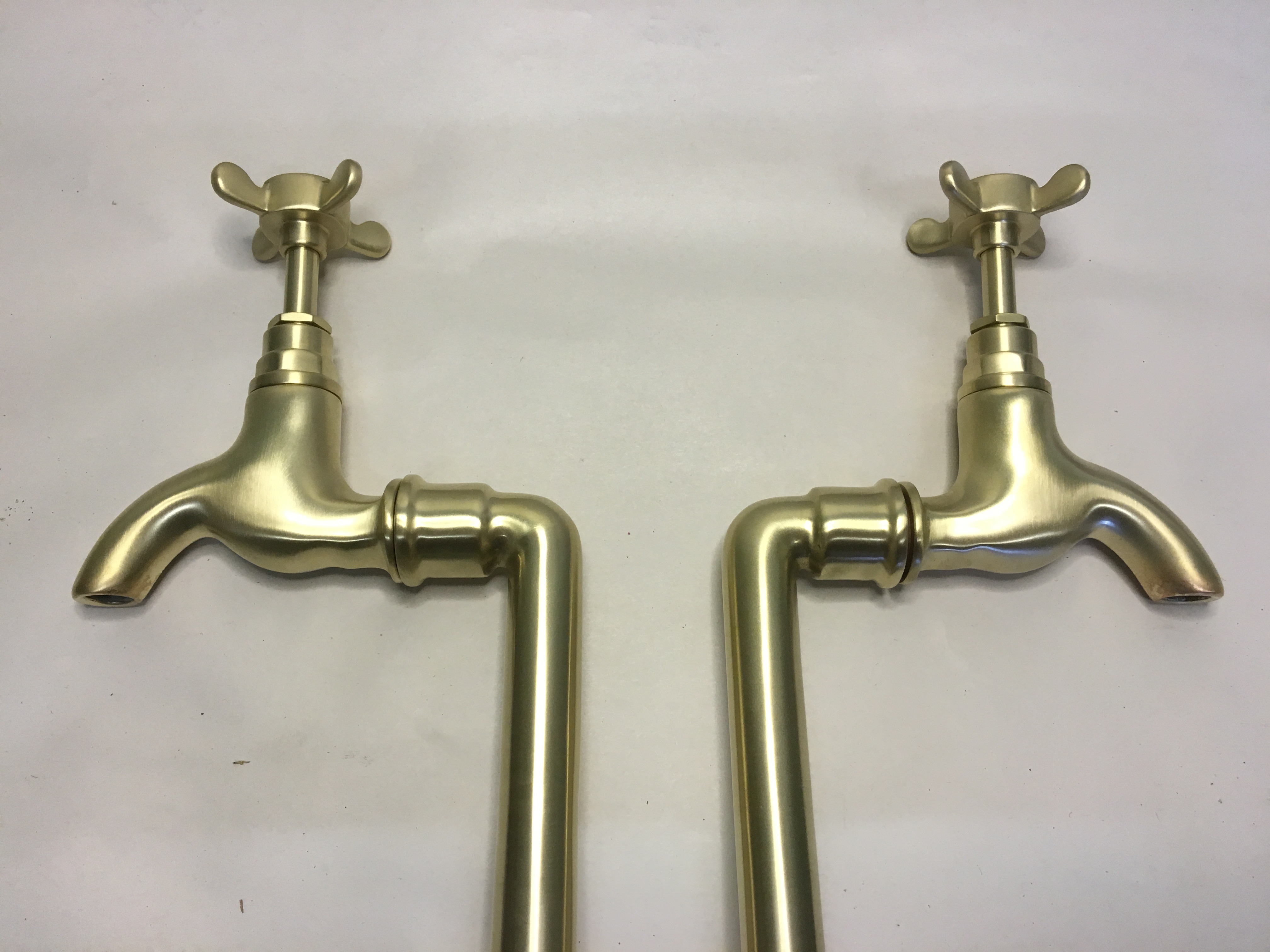 Bib taps on stands in “Brushed brass”.